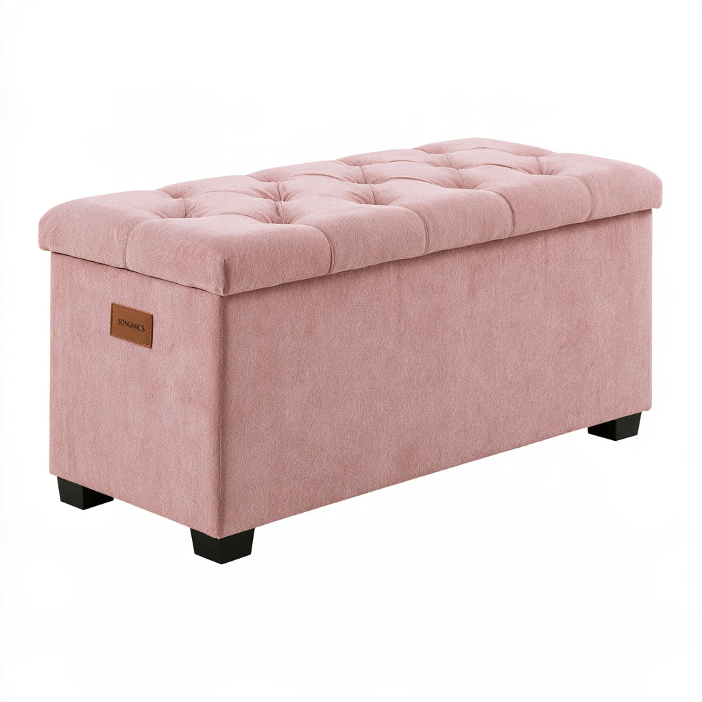 Pink velvet storage bench with tufted top and black feet, ideal as a stylish living room or home decor furniture piece.